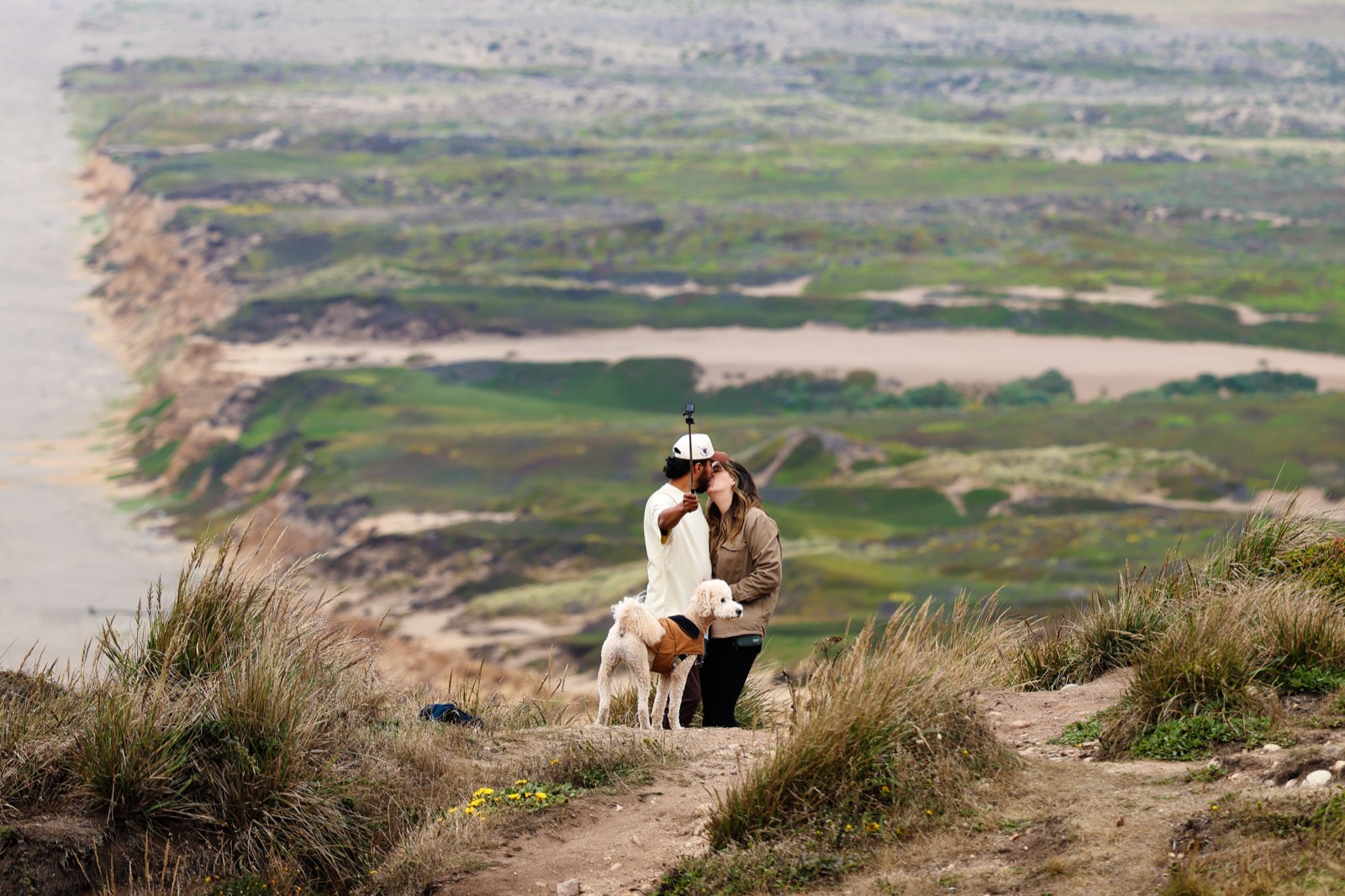 A person sitting in a wide green landscape