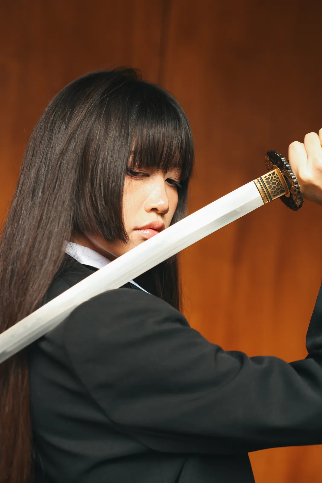 A dramatic portrait of a woman holding a sword